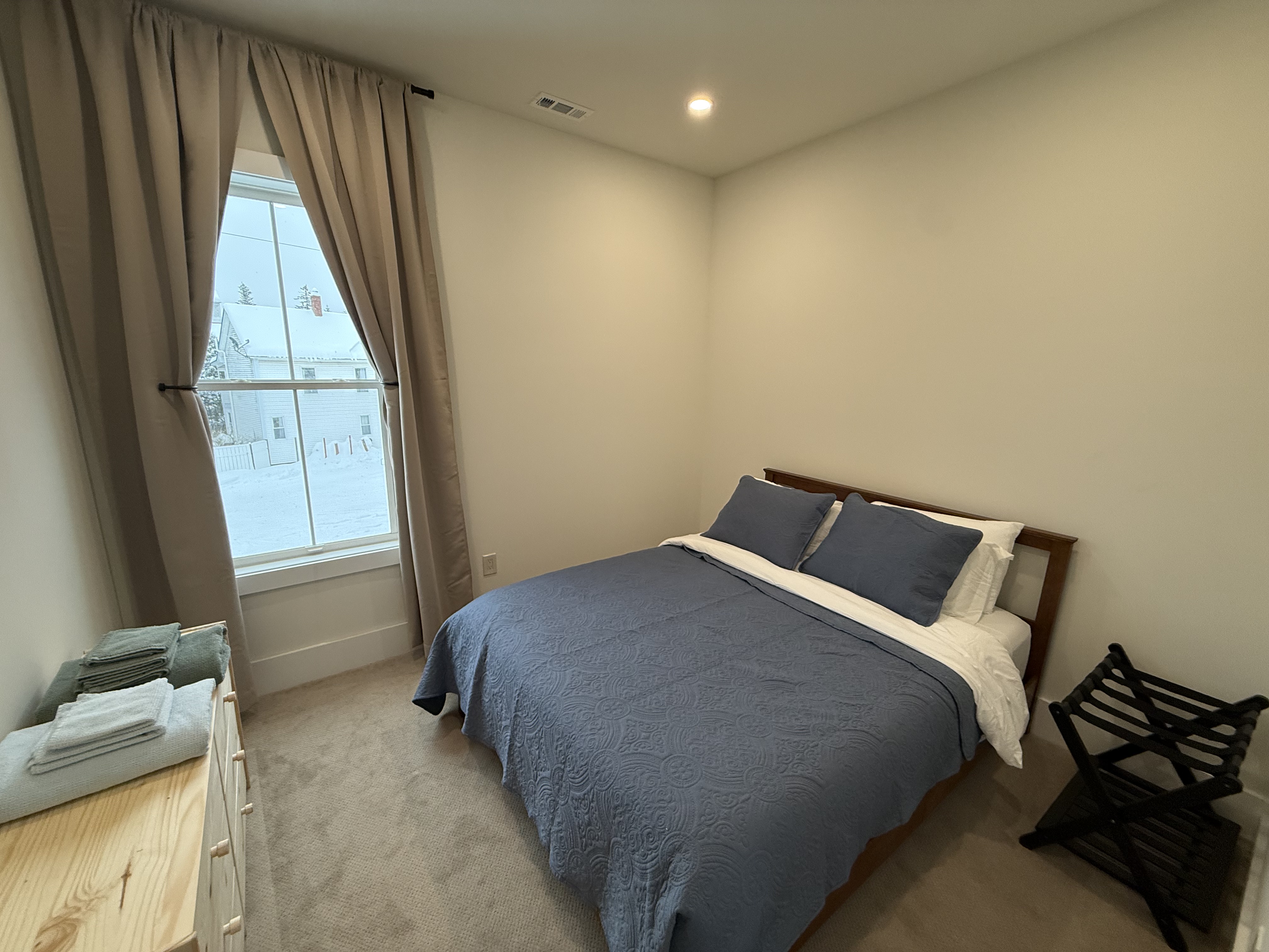 Bedroom four with dark wood bed frame